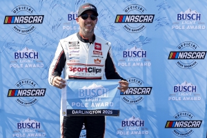 Denny Hamlin poses for photos after winning the pole for the Cook Out Southern 500 at Darlington Raceway on August 30, 2025.