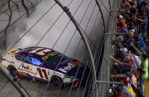 Denny Hamlin, driver of the #11 car for Joe Gibbs Racing, celebrates with a burnout in front of fans after winning at Bristol Motor Speedway on September 16, 2023.