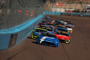 Denny Hamlin leads the field during the NASCAR Cup Series Championship at Phoenix Raceway on November 2, 2025. Hamlin was three laps away from a long-awaited title, when a flat tire from William Bryon led to a caution that would lead to Kyle Larson claiming the crown.