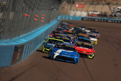 Denny Hamlin leads the field during the NASCAR Cup Series Championship at Phoenix Raceway on November 2, 2025. Hamlin was three laps away from a long-awaited title, when a flat tire from William Bryon led to a caution that would lead to Kyle Larson claiming the crown.