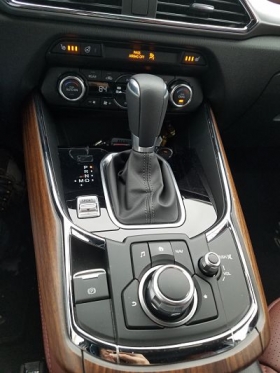 The Mazda infotainment system is controlled by a dial in the center console